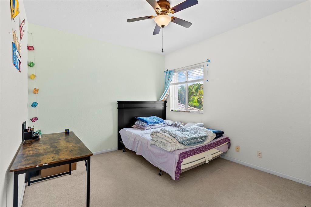 9728 Vineyard Court Boca Raton, FL 33428 - Photo 12 of 17 a bedroom with a bed and a window