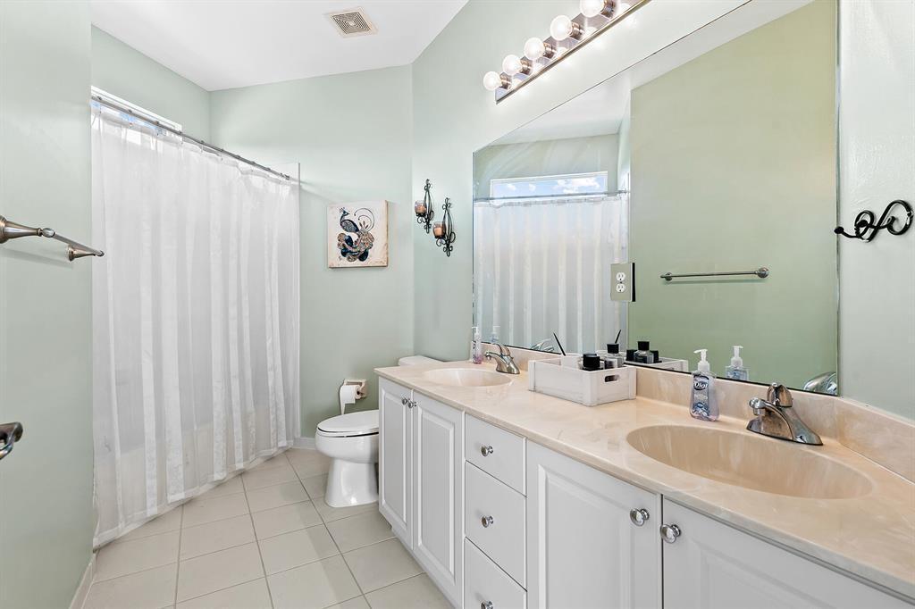 9728 Vineyard Court Boca Raton, FL 33428 - Photo 13 of 17 a bathroom with a double vanity sink mirror and toilet