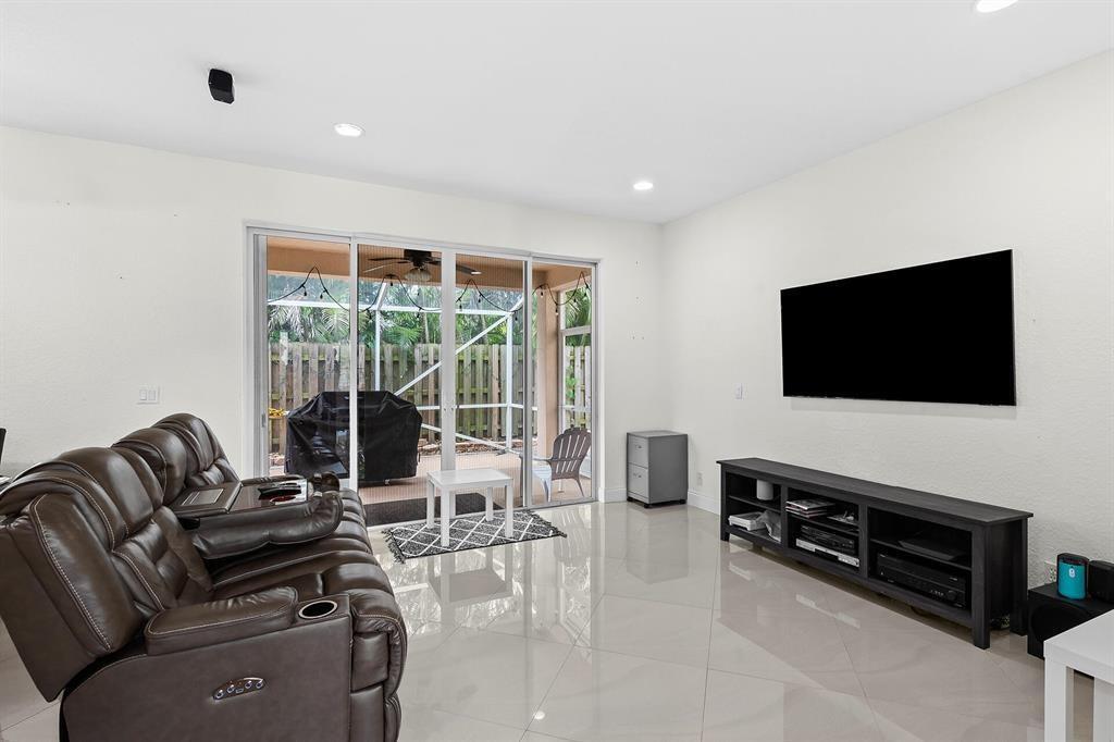 9728 Vineyard Court Boca Raton, FL 33428 - Photo 4 of 17 a living room with furniture and a flat screen tv