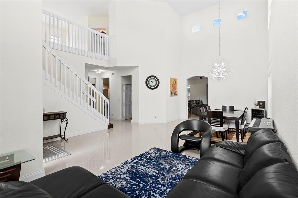 9728 Vineyard Court Boca Raton, FL 33428 - Photo 6 of 17 a living room with furniture a rug and white walls