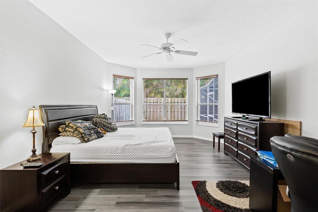 9728 Vineyard Court Boca Raton, FL 33428 - Photo 9 of 17 a bedroom with a bed and a flat screen tv