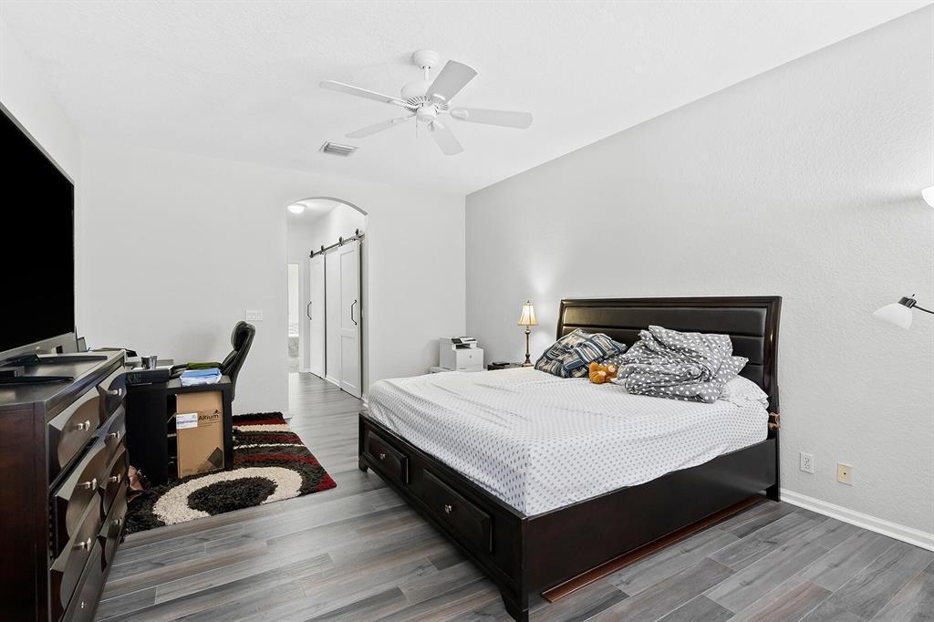 9728 Vineyard Court Boca Raton, FL 33428 - Photo 10 of 17 a bedroom with a bed and a desk