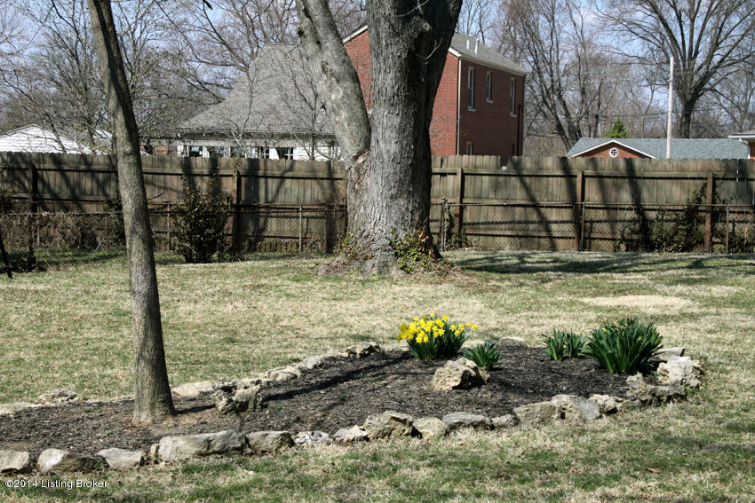 5409 Layne Road Louisville, KY 40219 - Photo 24 of 35 Creek rock landscaping bed! Notice the privacy fence along the back!