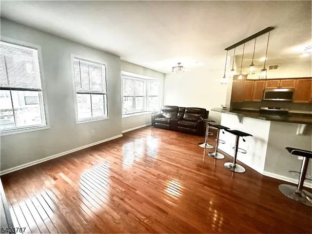 a living room with furniture window and wooden floor