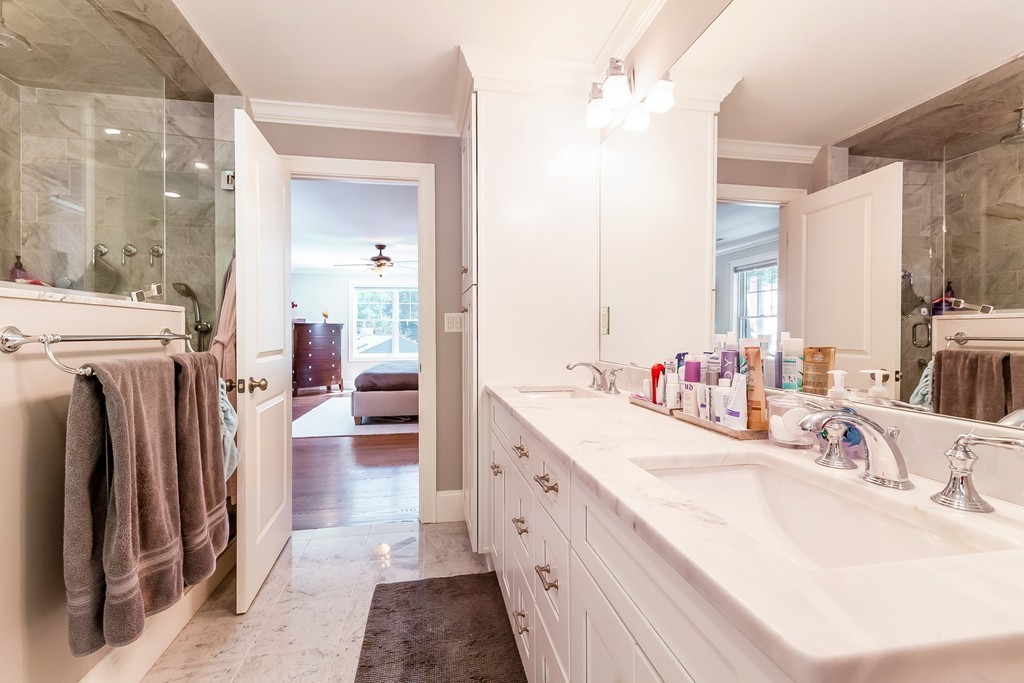 65 Leland Road Boston, MA 02467 - Photo 18 of 30 a en suite bathroom with a double vanity sink a mirror and a shower