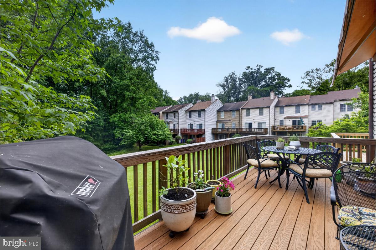 7347 Swan Point Way, Unit 122 Columbia, MD 21045 - Photo 16 of 54 a view of a deck with furniture and trees around