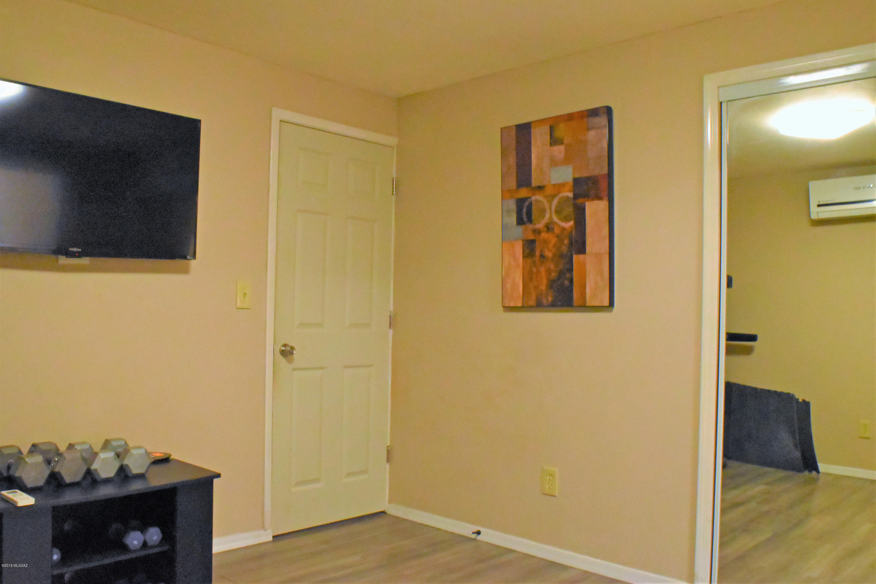 392 Willow Drive Rio Rico, AZ 85648 - Photo 21 of 25 a view of a hallway with wooden floor and closet