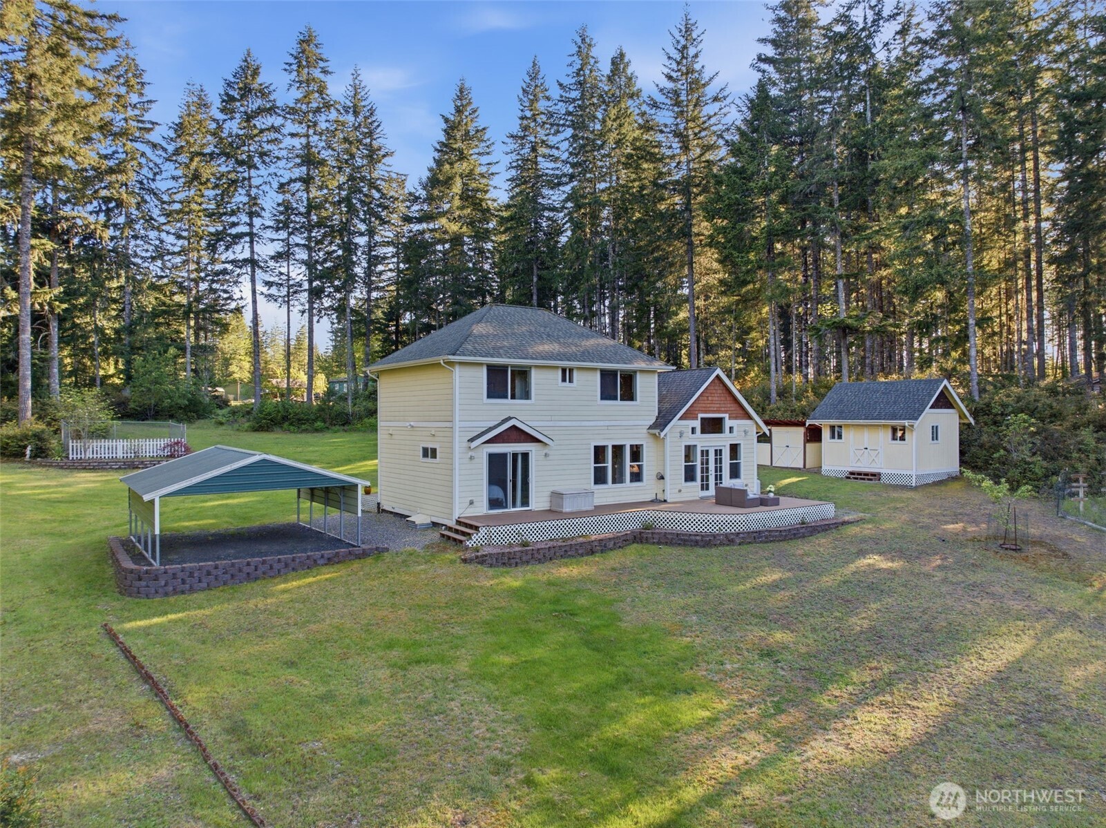 6971 Northeast Tahuya Blacksmith Road Belfair, WA 98528 - Photo 34 of 38 a front view of a house with a yard and trees