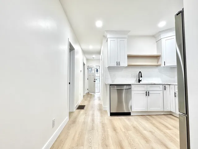 a kitchen with stainless steel appliances granite countertop a sink and cabinets
