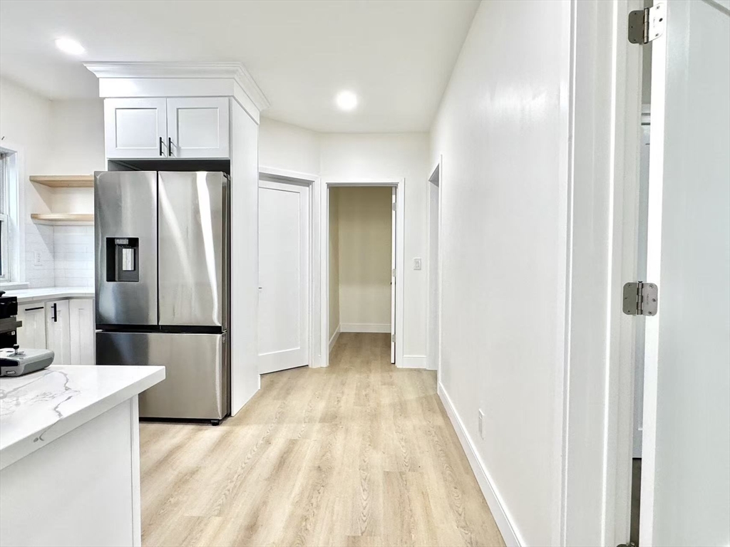 78 Orchard Street, Unit 78 Medford, MA 02155 - Photo 3 of 11 a view of a kitchen with a refrigerator a sink dishwasher and a refrigerator