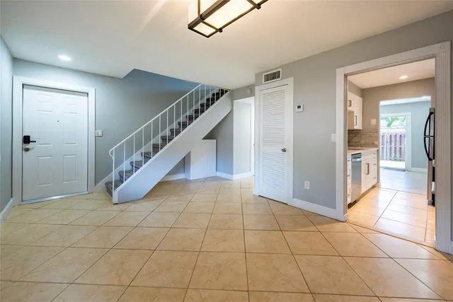 a view of a hallway with entryway and hall with a living room view