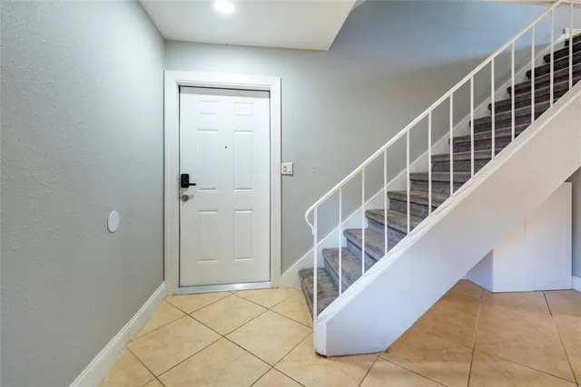a view of staircase with white walls and windows