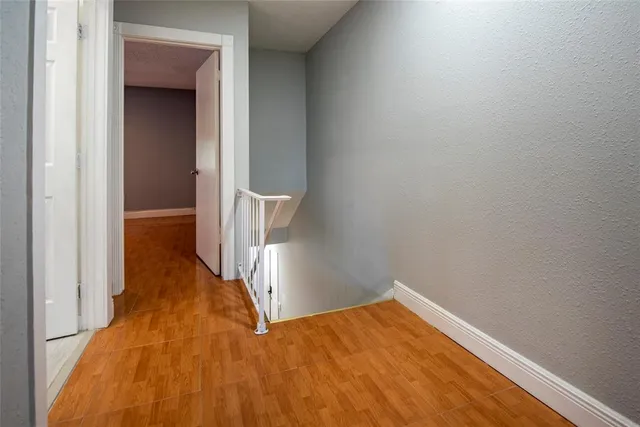 a view of hallway with wooden floor