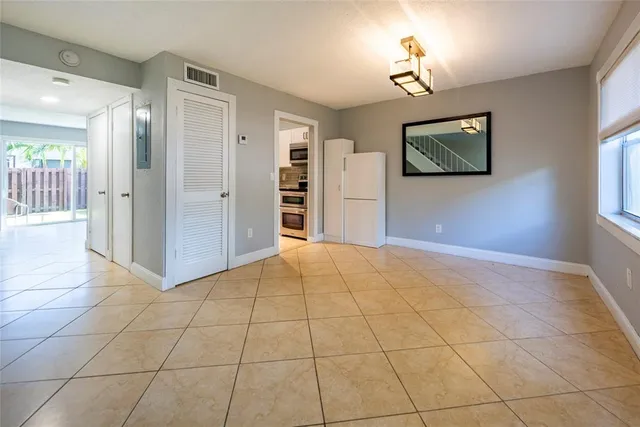 a view of a livingroom with wooden floor and a ceiling fan