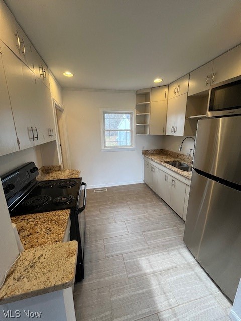 9660 Repp Road West Salem, OH 44287 - Photo 8 of 28 Kitchen featuring refrigerator, sink, light stone countertops, and stove