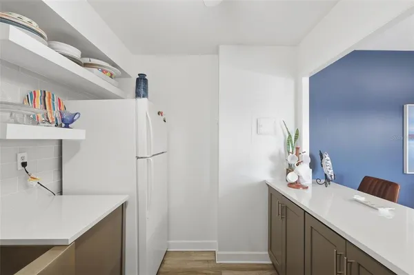 a view of a living room with furniture and book shelf