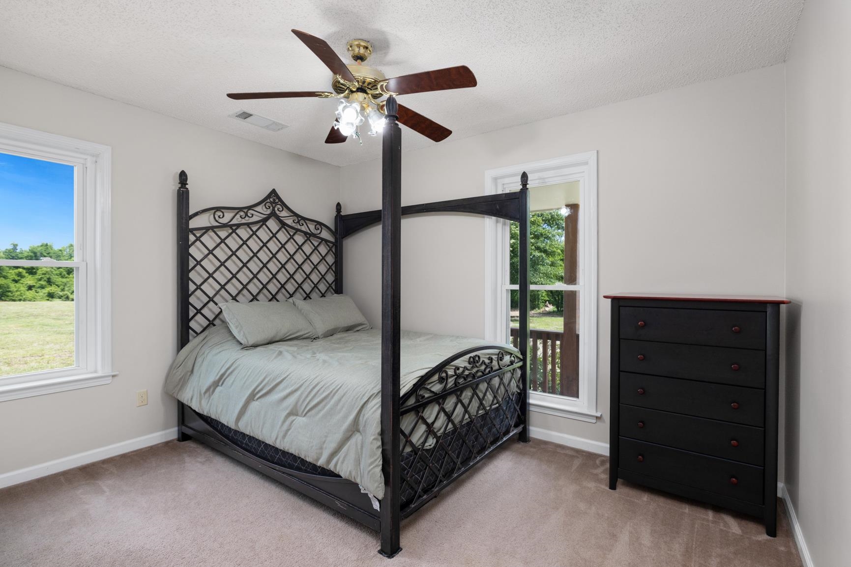 8539 Campground Road Drummonds, TN 38023 - Photo 23 of 38 a bedroom with a bed chandelier and a window
