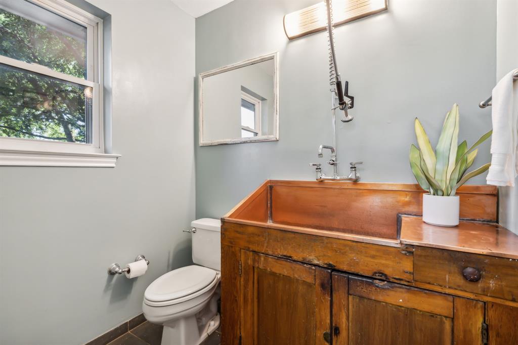 1980 Winningkoff Road Lucas, TX 75002 - Photo 27 of 35 Custom wood vanity with an integrated copper sink, complemented by a wall-mounted faucet with a pull-down sprayer, and a rectangular framed mirror