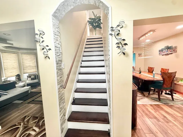 a spacious bedroom with a bed and wooden floor