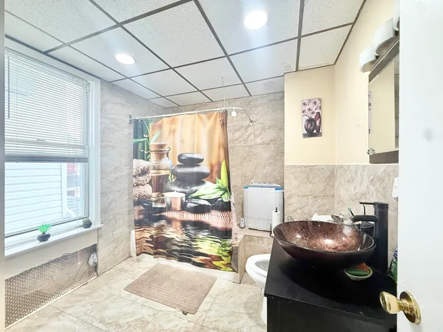 a view of a bathroom with a tub and a window