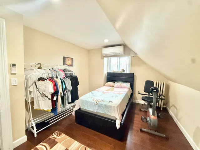a bedroom with a bed and a window with rug