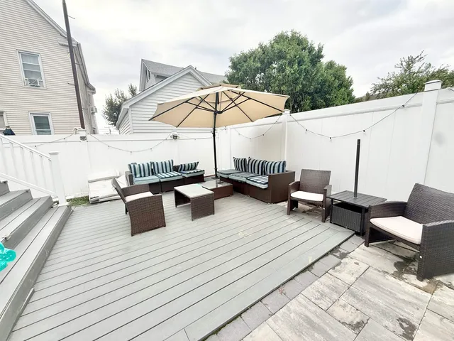 a roof deck with table and chairs