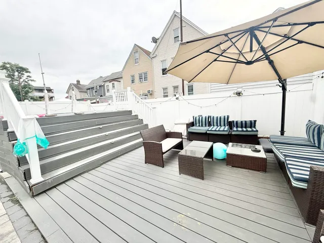 a backyard of a house with barbeque oven table and chairs