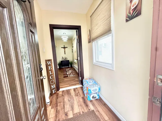 a view of an entryway with wooden floor