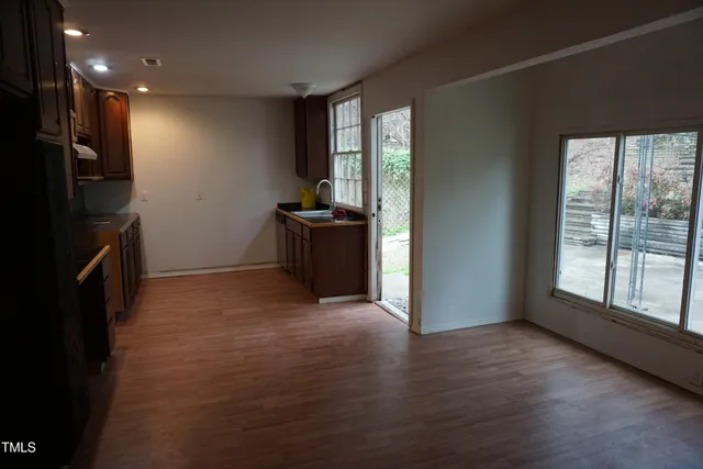 a view of hallway with stairs and wooden floor