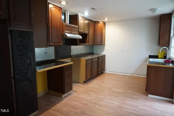 a kitchen with stainless steel appliances granite countertop a stove a refrigerator and a sink