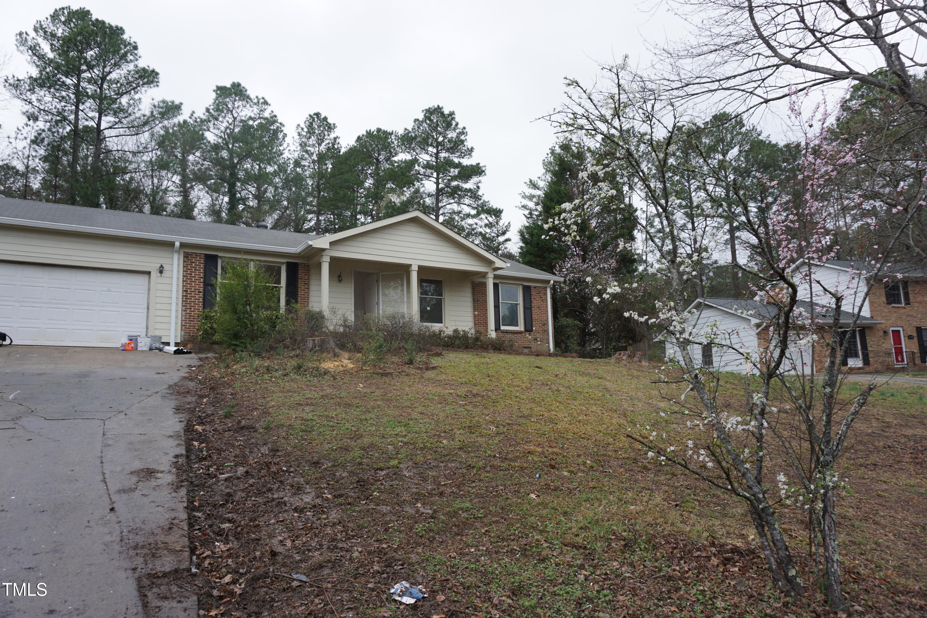 5504 Pelham Road Durham, NC 27713 - Photo 2 of 23 a view of a yard in front of a house with large trees
