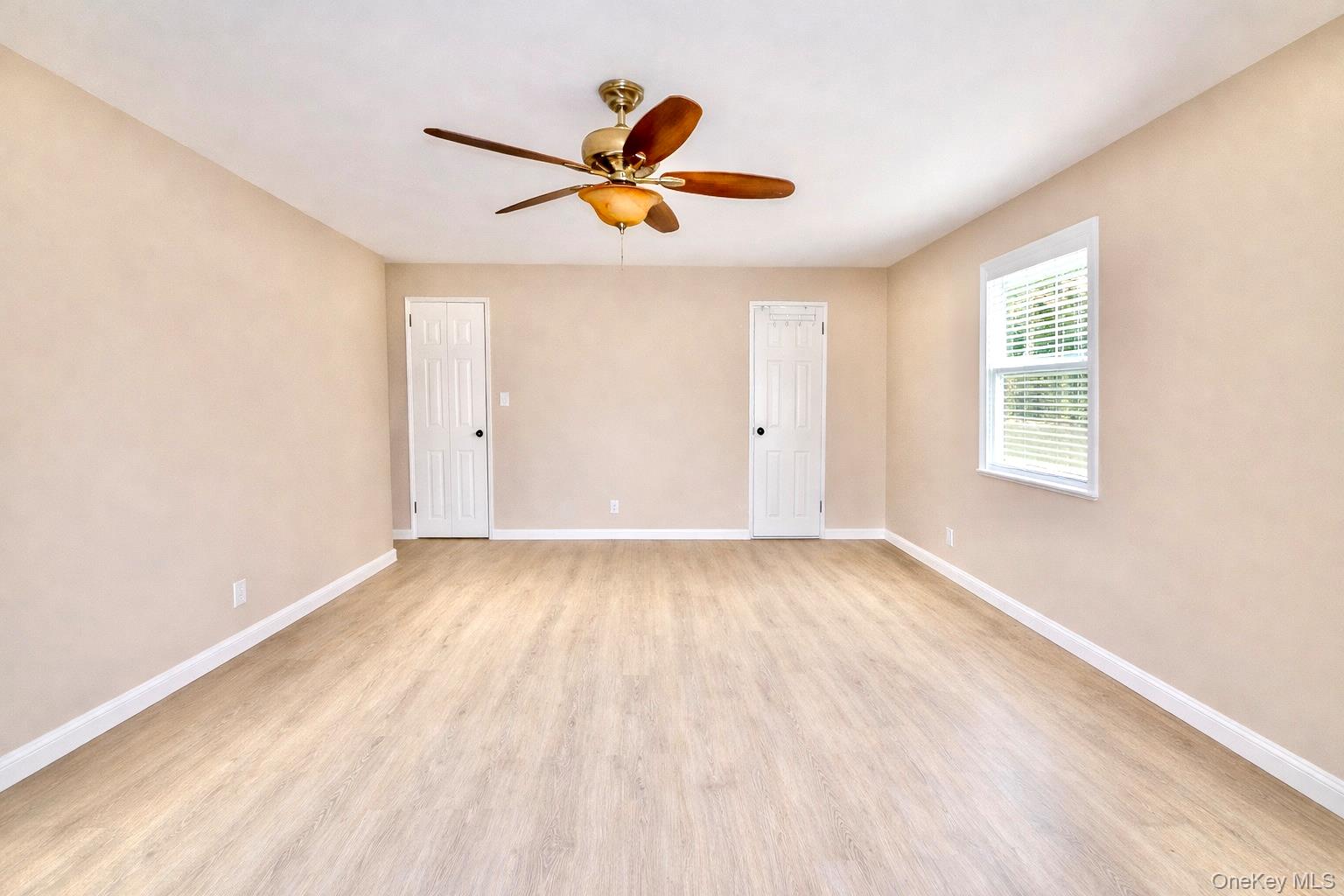 245 Rumsey Road, Unit 3E Yonkers, NY 10701 - Photo 12 of 24 a view of empty room with wooden floor and fan