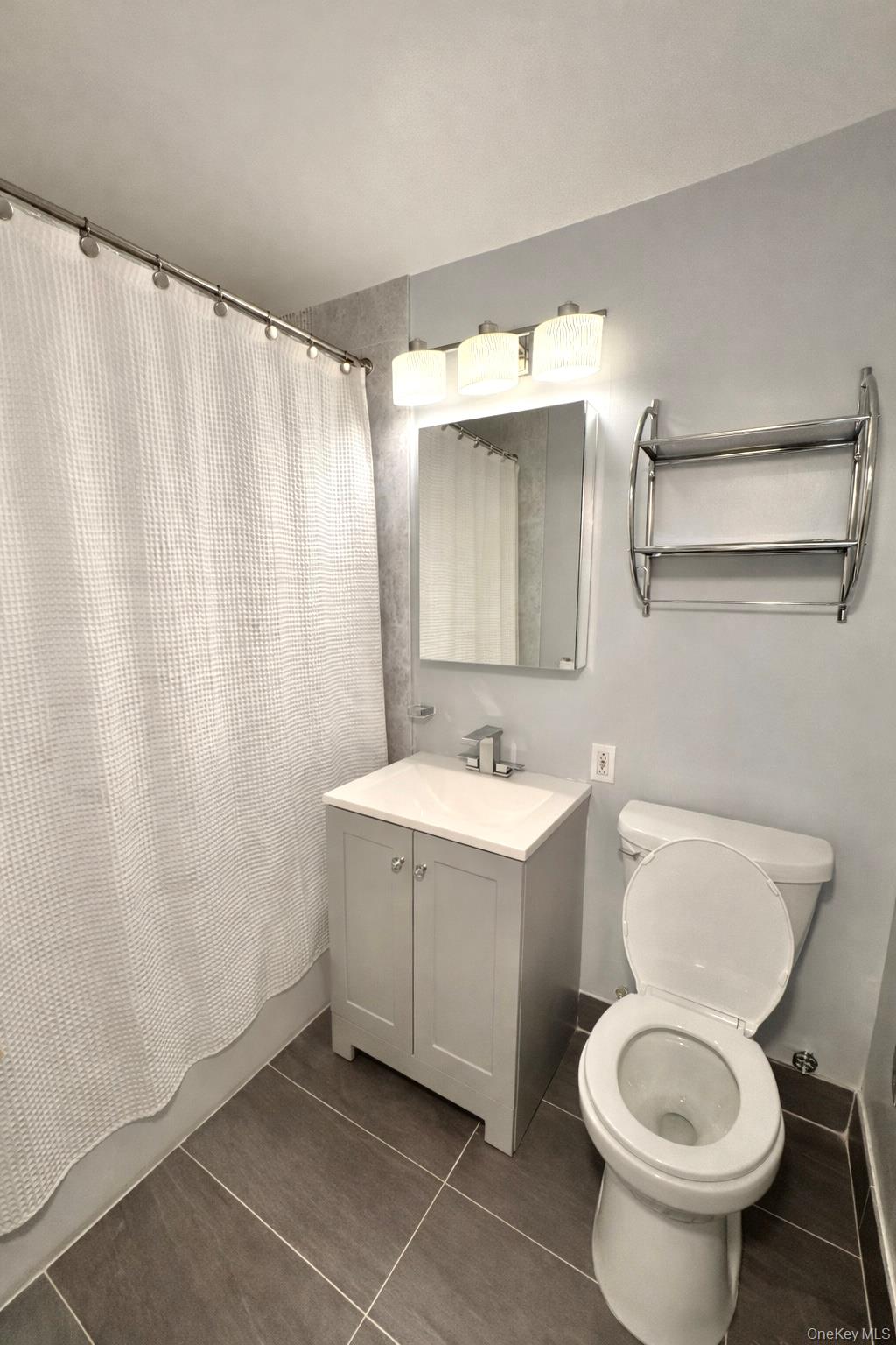 245 Rumsey Road, Unit 3E Yonkers, NY 10701 - Photo 17 of 24 a bathroom with a sink a toilet and shower