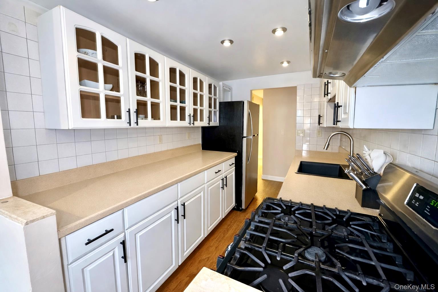 245 Rumsey Road, Unit 3E Yonkers, NY 10701 - Photo 8 of 24 a kitchen with a stove and a sink