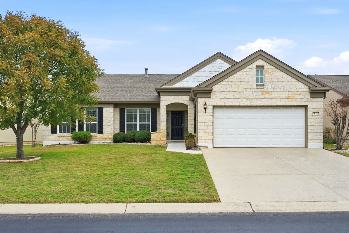 a view of a house with garden and trees