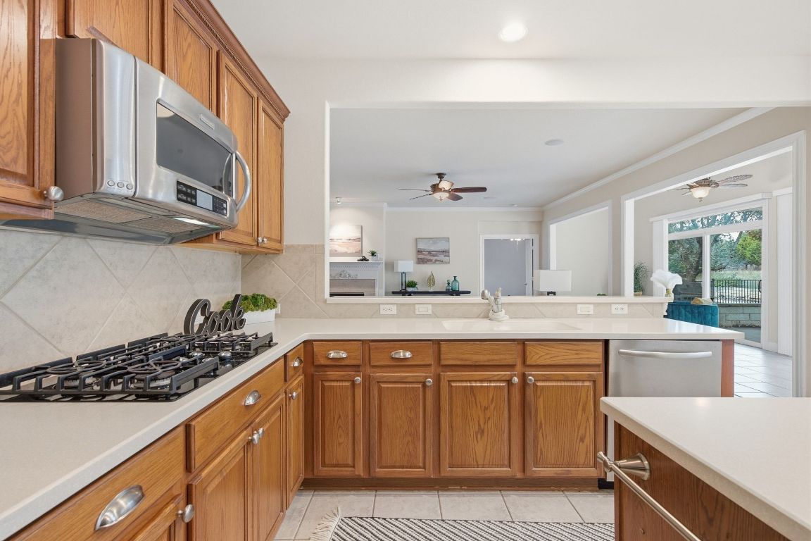 512 Armstrong Drive Georgetown, TX 78633 - Photo 19 of 40 a kitchen with a sink stove top oven and cabinets