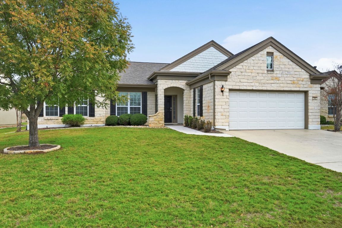 512 Armstrong Drive Georgetown, TX 78633 - Photo 2 of 40 a front view of a house with a garden and trees