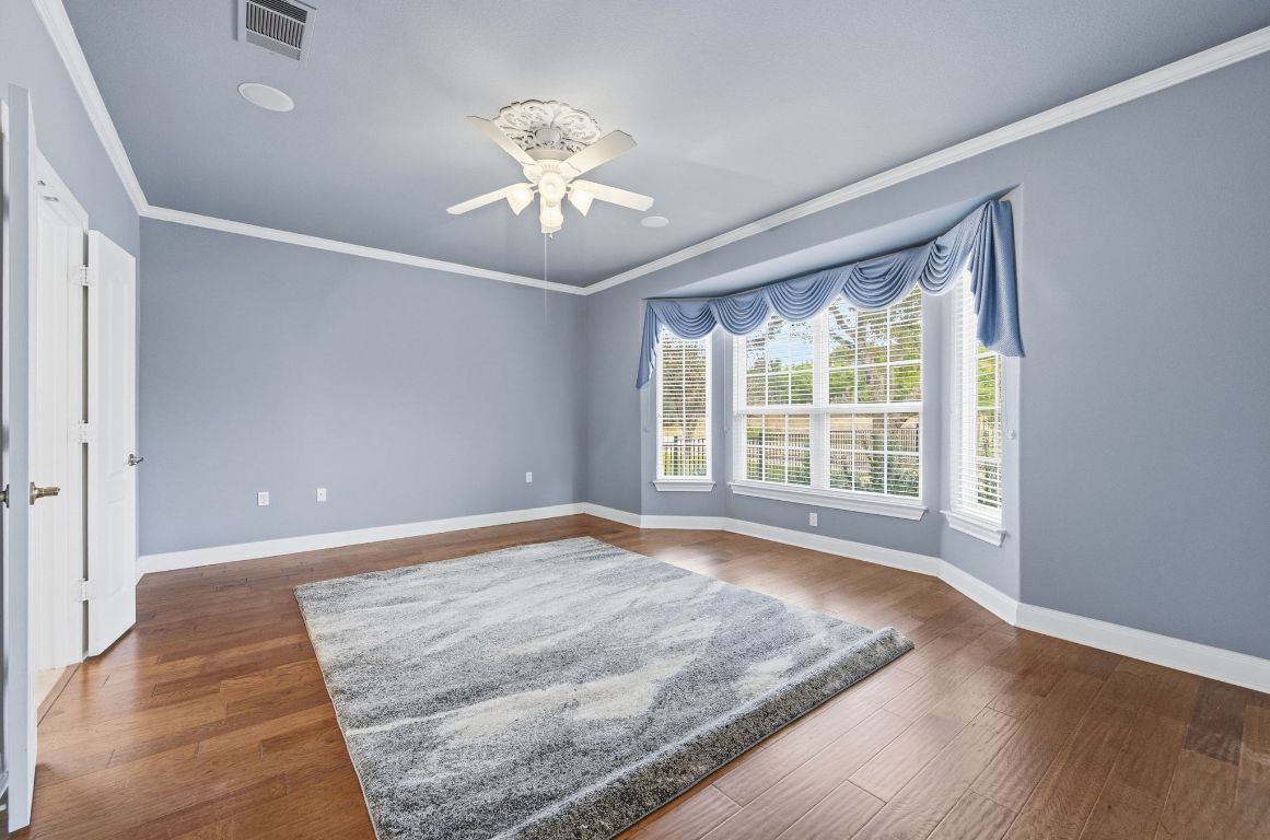 512 Armstrong Drive Georgetown, TX 78633 - Photo 24 of 40 a view of an empty room with wooden floor and a window