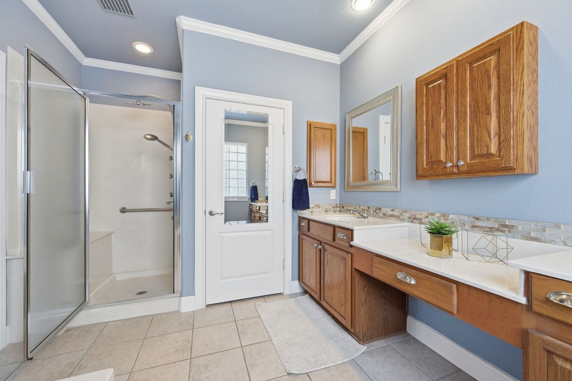 512 Armstrong Drive Georgetown, TX 78633 - Photo 28 of 40 a bathroom with a sink a mirror and a shower