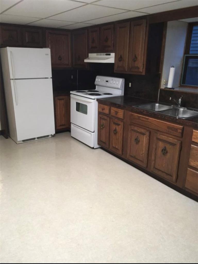 69 West Ridge Street Nesquehoning, PA 18240 - Photo 2 of 8 Well-equipped kitchen features ample wood cabinetry and white appliances, perfect for daily meal preparation.