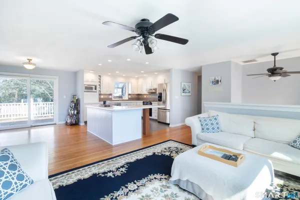 a living room with furniture and kitchen view