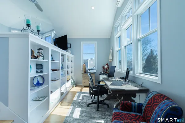 a living room with furniture a rug and a window