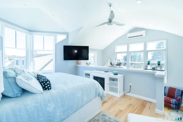 a bedroom with a bed and a flat screen tv