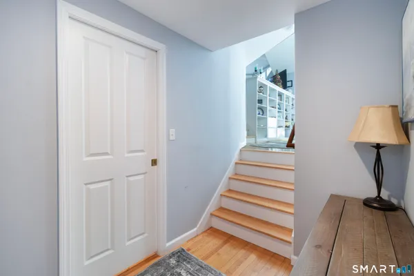 a view of entryway with wooden floor and cabinet