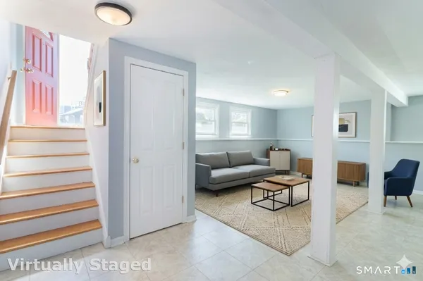 a living room with furniture and a painting on the wall