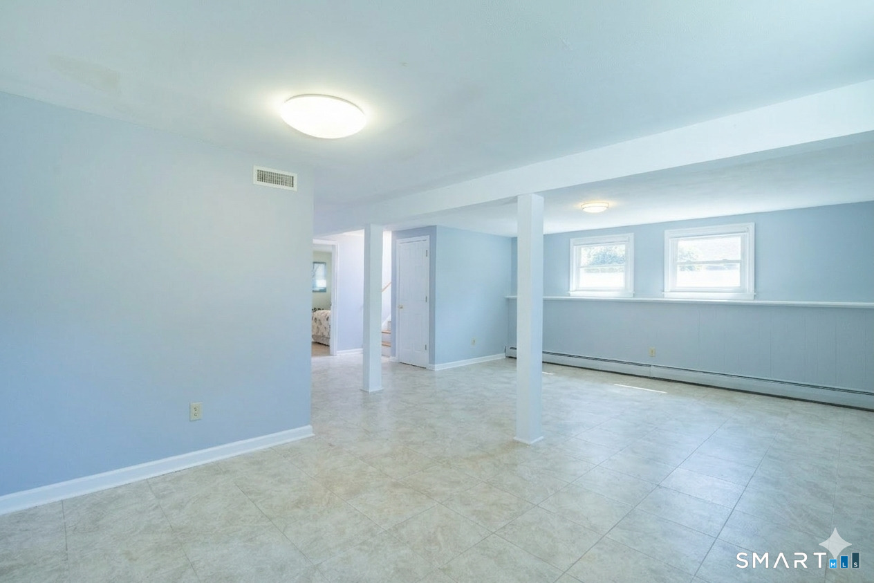 24 Indian Drive Clinton, CT 06413 - Photo 36 of 46 Another view of the family room shows how it extends around the corner. See the virtual staging in the next photo.