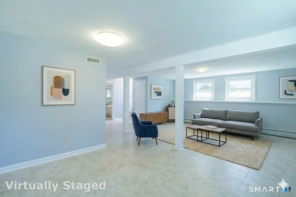 a living room with furniture and a potted plant