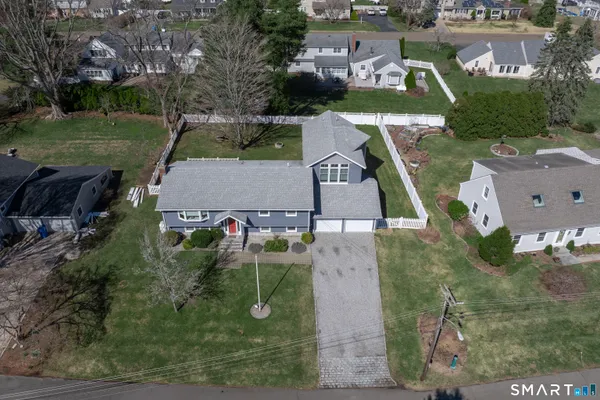 an aerial view of a house with a garden and trees