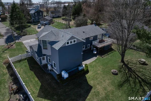 an aerial view of a house with swimming pool and trees