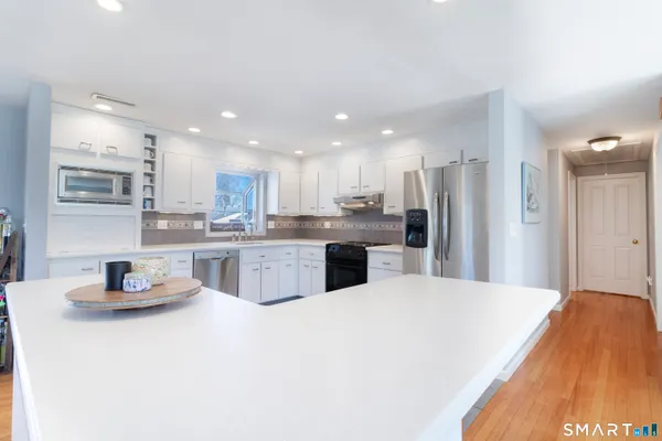 a kitchen with a refrigerator and a sink